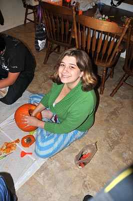 Anna carving her pumpkin